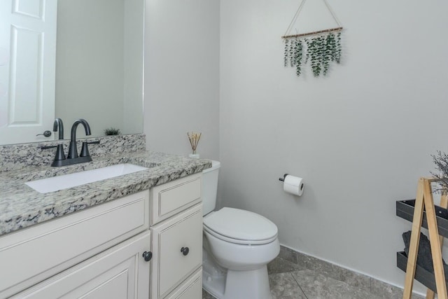 bathroom with tile patterned floors, vanity, and toilet