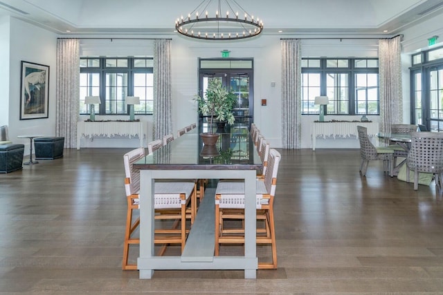 dining space with dark hardwood / wood-style floors and a chandelier