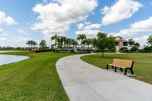 surrounding community featuring a water view and a yard