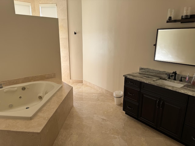 bathroom with vanity and tiled tub