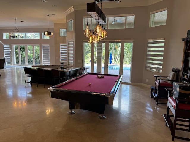 playroom with french doors, billiards, crown molding, and a high ceiling