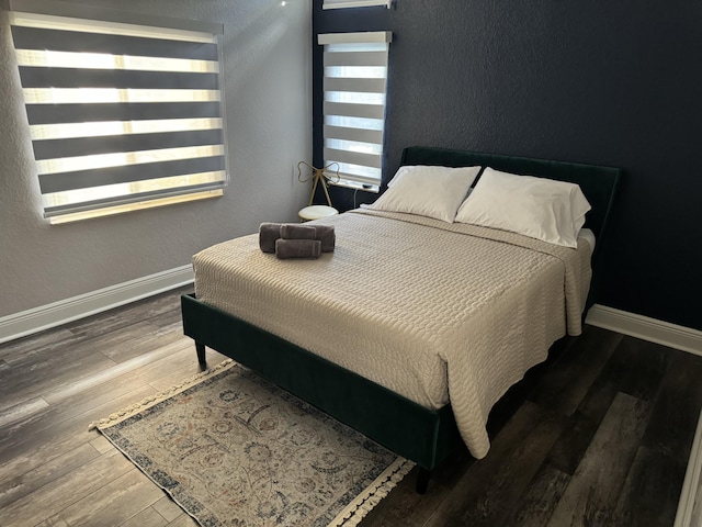 bedroom featuring dark hardwood / wood-style flooring