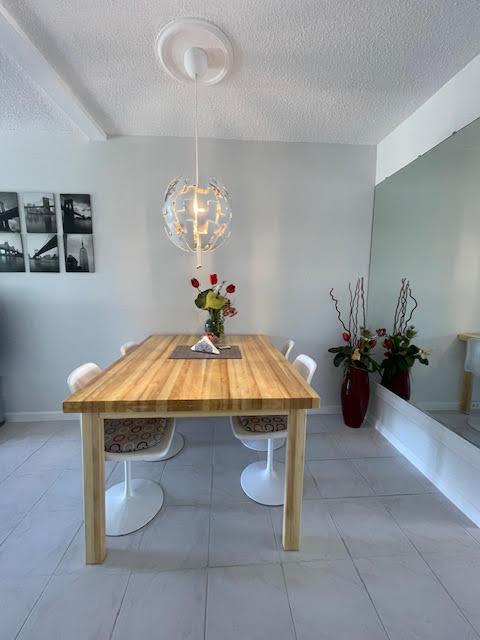 unfurnished dining area with a textured ceiling