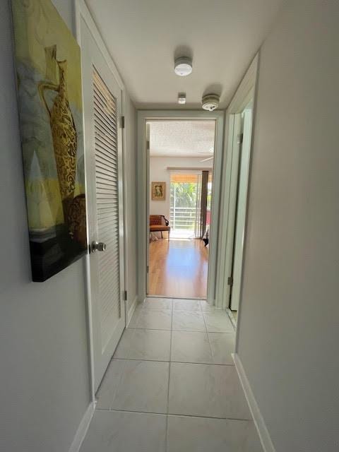 hallway with light tile patterned flooring