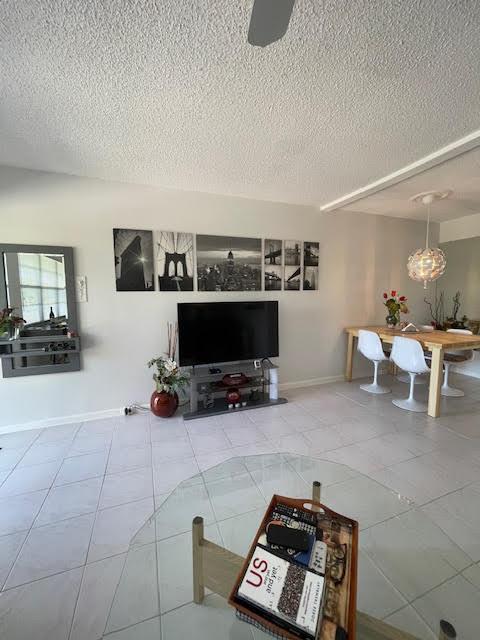 tiled living room with a textured ceiling