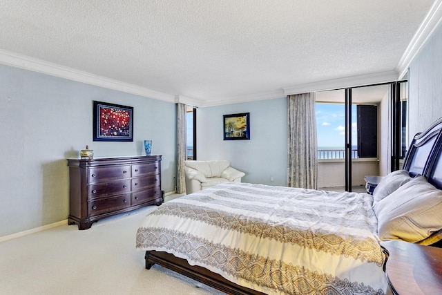 bedroom featuring ornamental molding, light colored carpet, and a textured ceiling