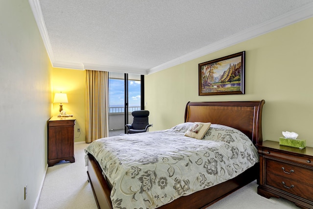 carpeted bedroom featuring ornamental molding and a textured ceiling