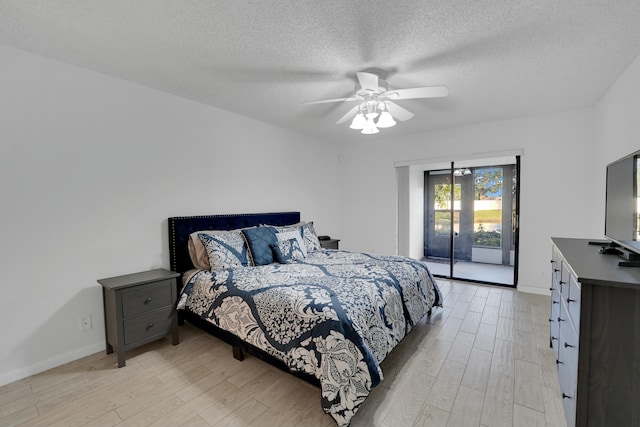 bedroom with ceiling fan, access to outside, light hardwood / wood-style floors, and a textured ceiling