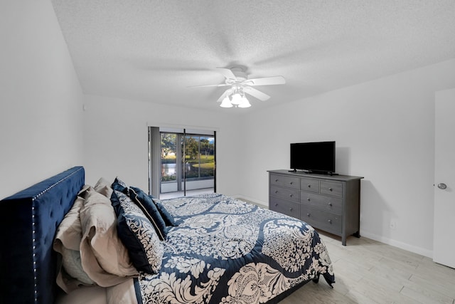 bedroom featuring ceiling fan, a textured ceiling, and light hardwood / wood-style flooring