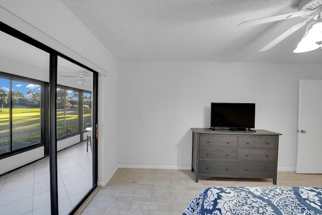 bedroom featuring ceiling fan, a textured ceiling, and access to outside