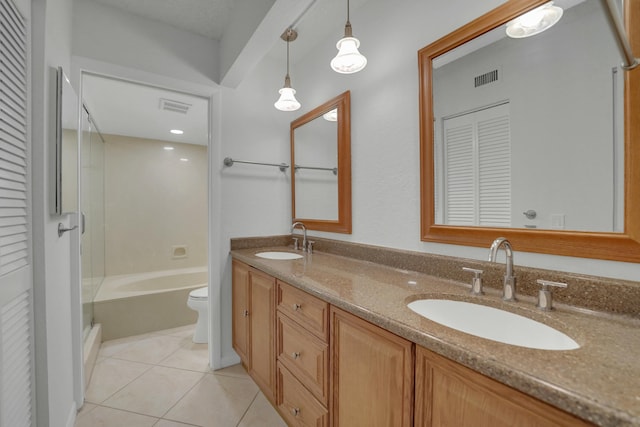 bathroom with tile patterned flooring, vanity, and toilet