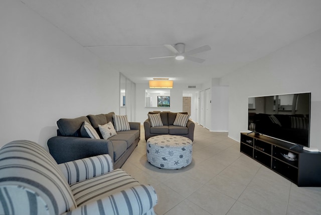 living room featuring light tile patterned floors and ceiling fan