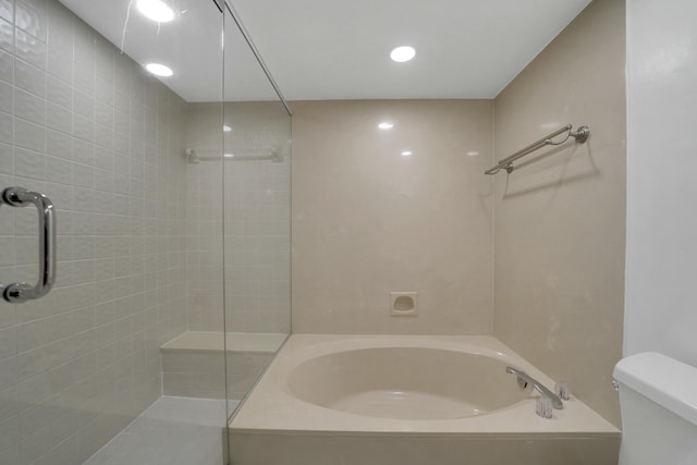 bathroom featuring toilet and separate shower and tub