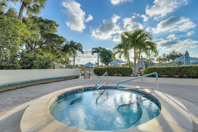 view of pool featuring an in ground hot tub