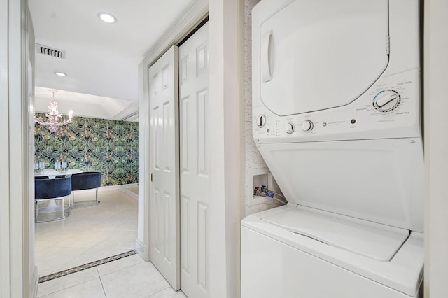 laundry area with stacked washer and dryer, recessed lighting, visible vents, laundry area, and wallpapered walls