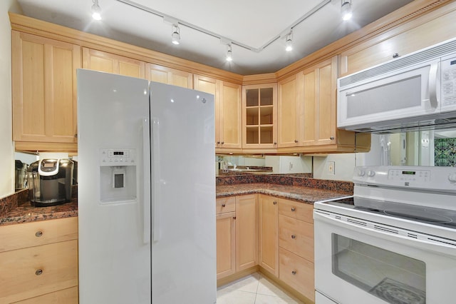 kitchen featuring light brown cabinetry, white appliances, light tile patterned flooring, and glass insert cabinets