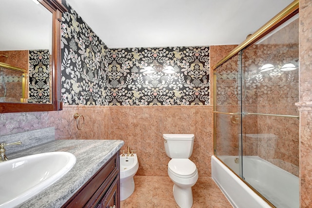 full bath featuring toilet, a bidet, vanity, and tile walls