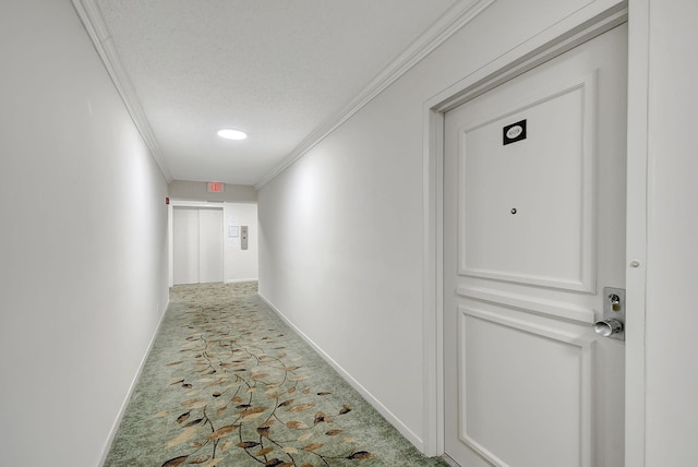 corridor with a textured ceiling, ornamental molding, and baseboards