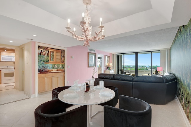 dining room with expansive windows, light tile patterned floors, and baseboards