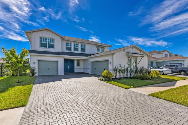 view of front of property featuring a garage and a front lawn