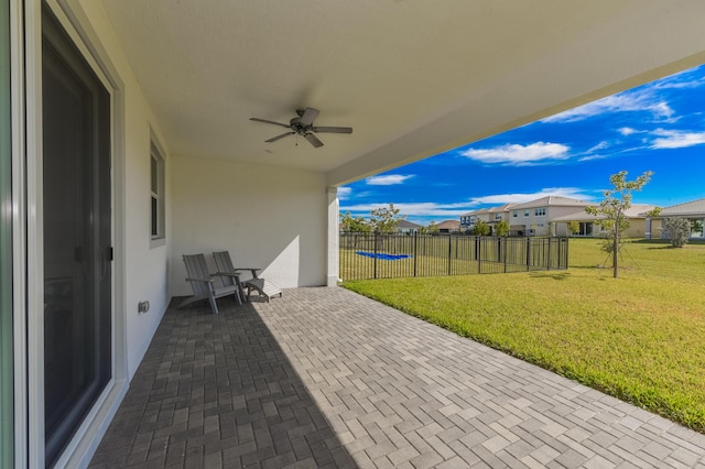 view of patio featuring a trampoline and ceiling fan