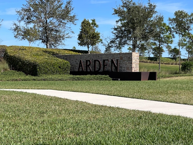 community sign featuring a lawn