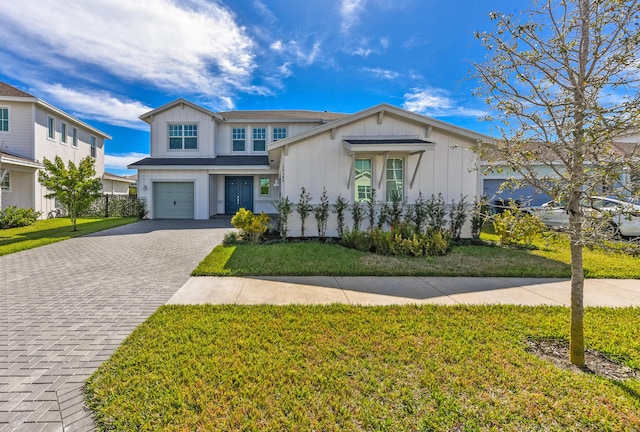 view of front of property featuring a garage and a front yard