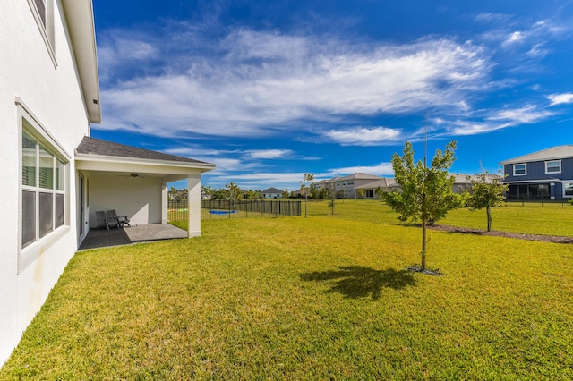 view of yard with a trampoline and a patio area