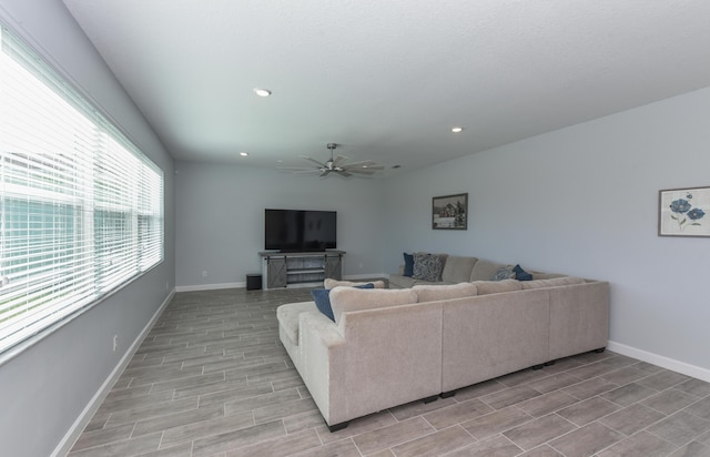 living room with ceiling fan and light hardwood / wood-style floors