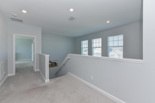 corridor with light colored carpet