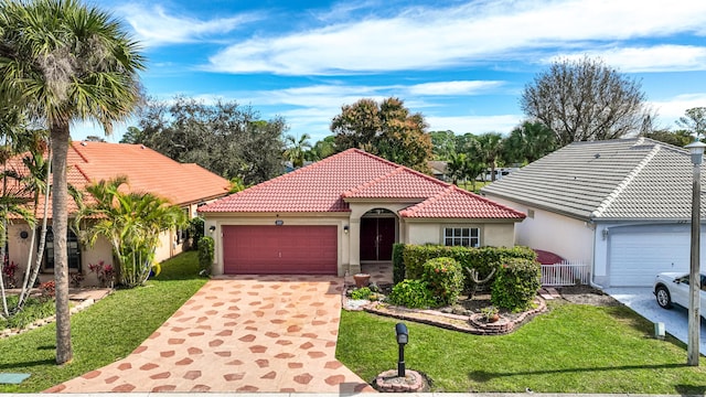 mediterranean / spanish house featuring a garage and a front lawn