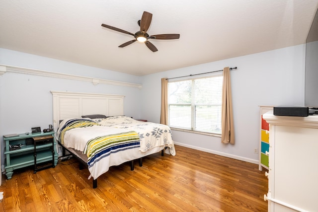 bedroom featuring wood-type flooring and ceiling fan