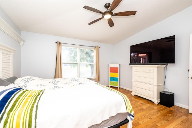 bedroom with lofted ceiling, hardwood / wood-style floors, and ceiling fan