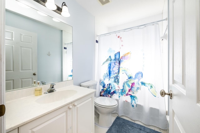 full bathroom with vanity, shower / bath combo, and toilet