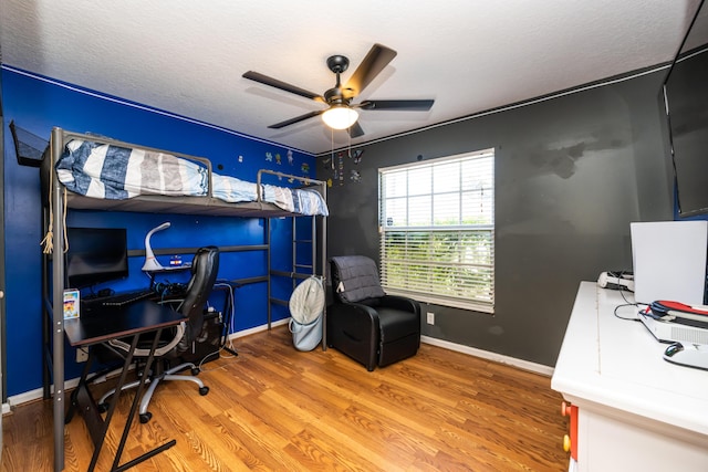 office space with hardwood / wood-style flooring, ceiling fan, and a textured ceiling