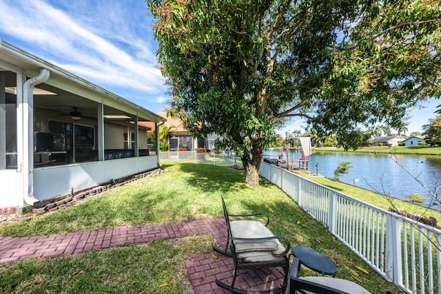 view of yard with a water view and a sunroom