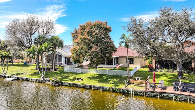 dock area with a water view and a lawn