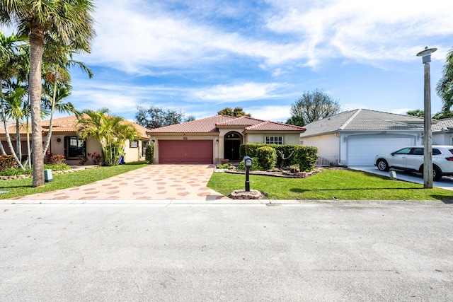 view of front of property with a garage and a front yard