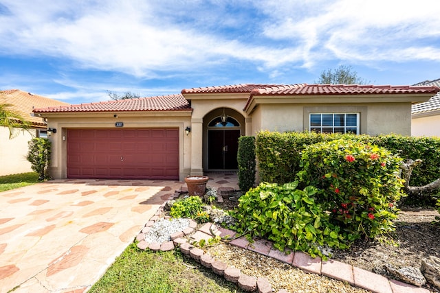 mediterranean / spanish-style home with a garage