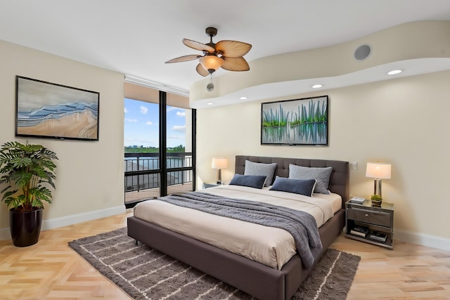 bedroom with ceiling fan, access to exterior, a water view, expansive windows, and light parquet flooring