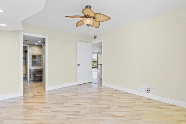 unfurnished room featuring ceiling fan and light hardwood / wood-style floors