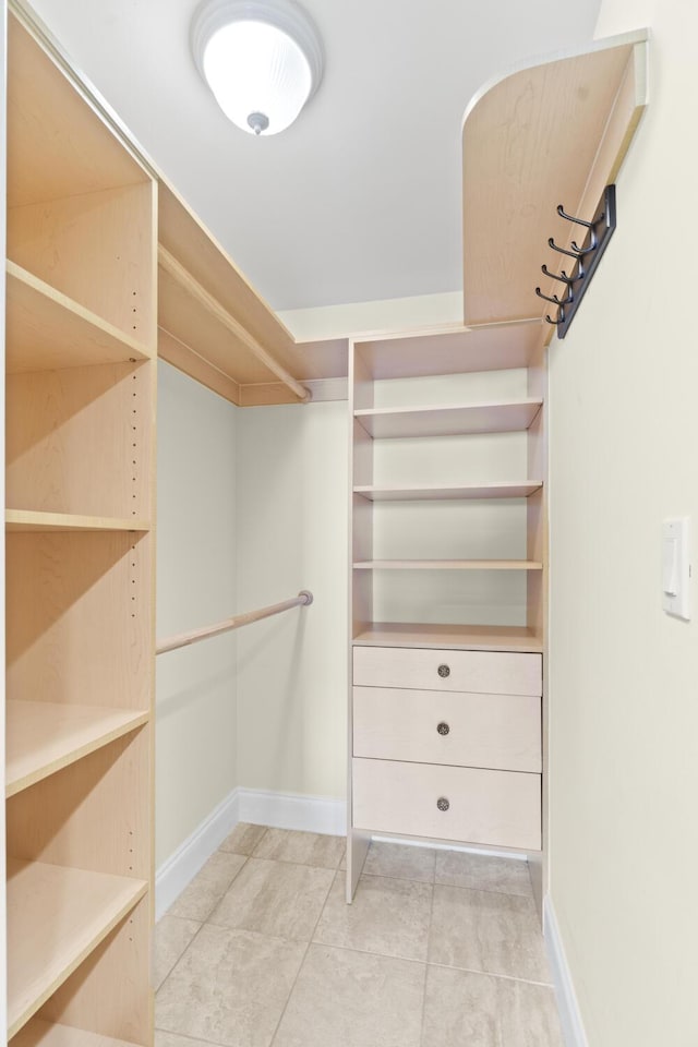 walk in closet featuring light tile patterned flooring