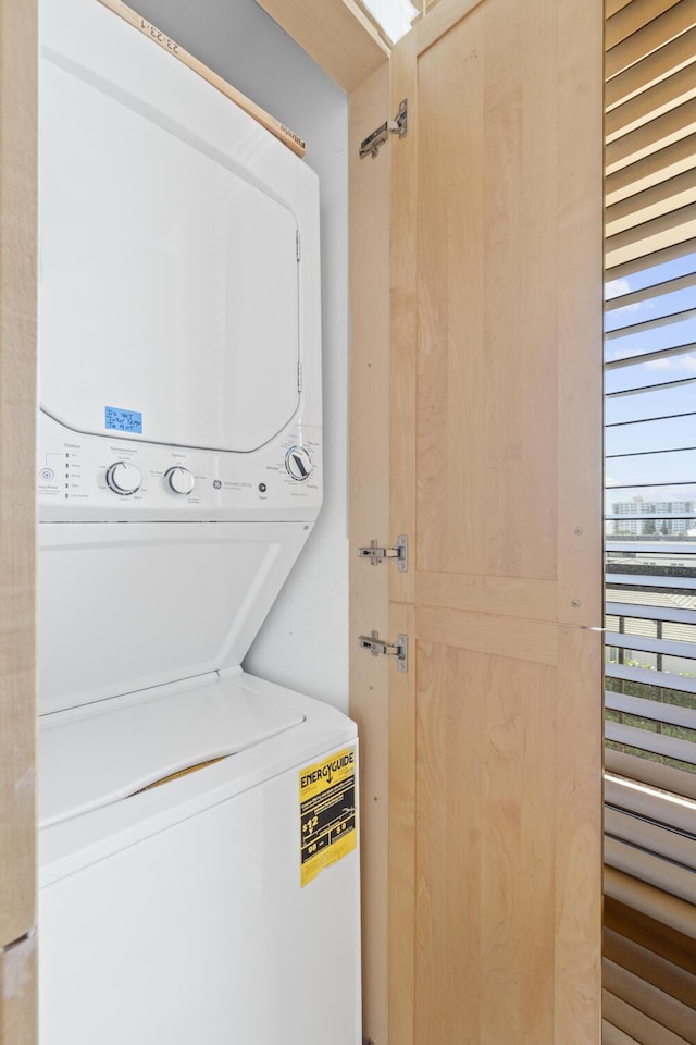 laundry area featuring stacked washing maching and dryer