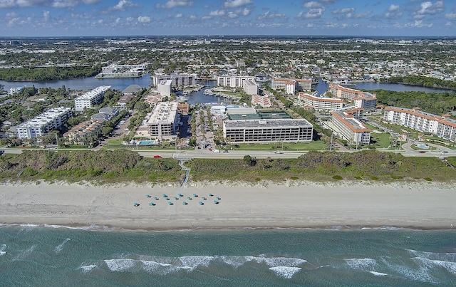 aerial view with a water view and a beach view