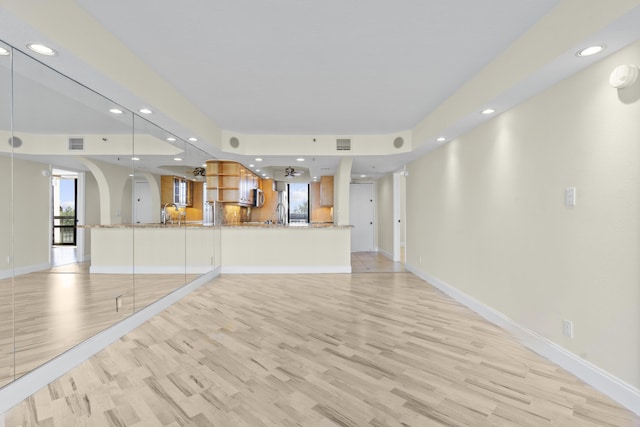 unfurnished living room with plenty of natural light and light wood-type flooring