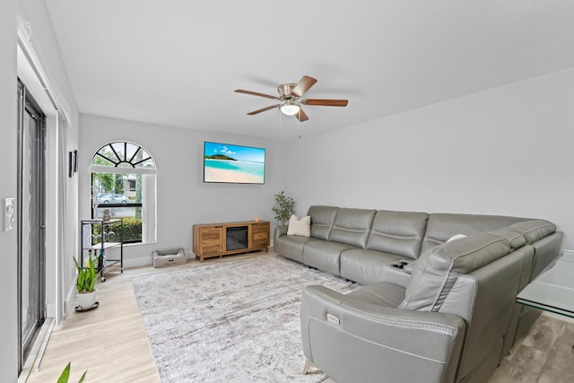 living room featuring light hardwood / wood-style flooring and ceiling fan