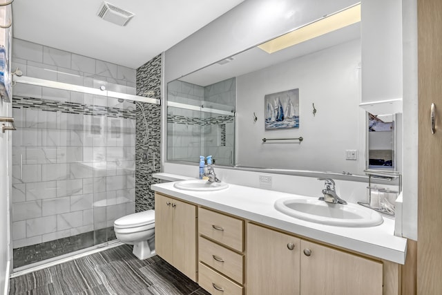 bathroom with vanity, toilet, and an enclosed shower