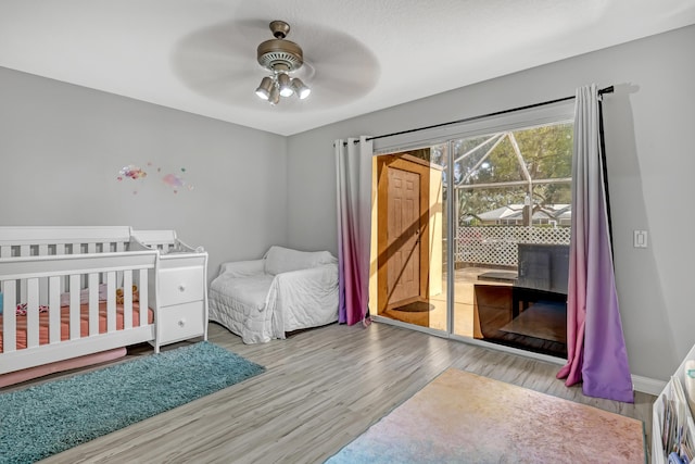 bedroom featuring access to exterior, ceiling fan, and light wood-type flooring