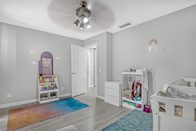 bedroom with ceiling fan and light hardwood / wood-style floors