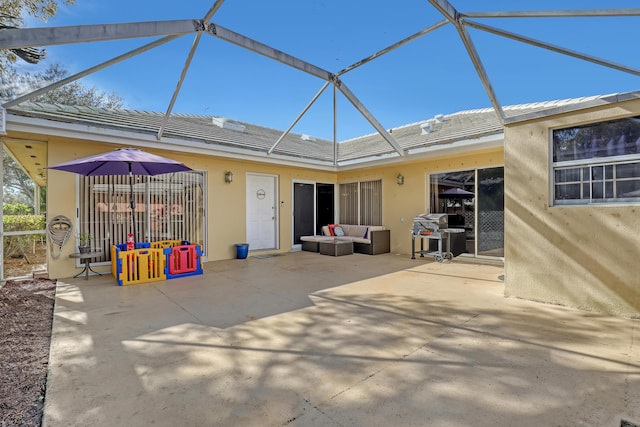 back of house with a lanai, outdoor lounge area, and a patio